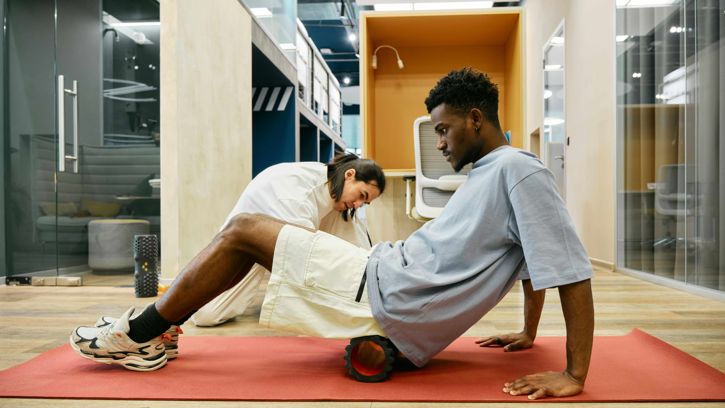 Physical therapist guiding a patient through a foam rolling exercise | Castine Concierge Physical Therapy | Mobile Physical Therapy Services Washington DC